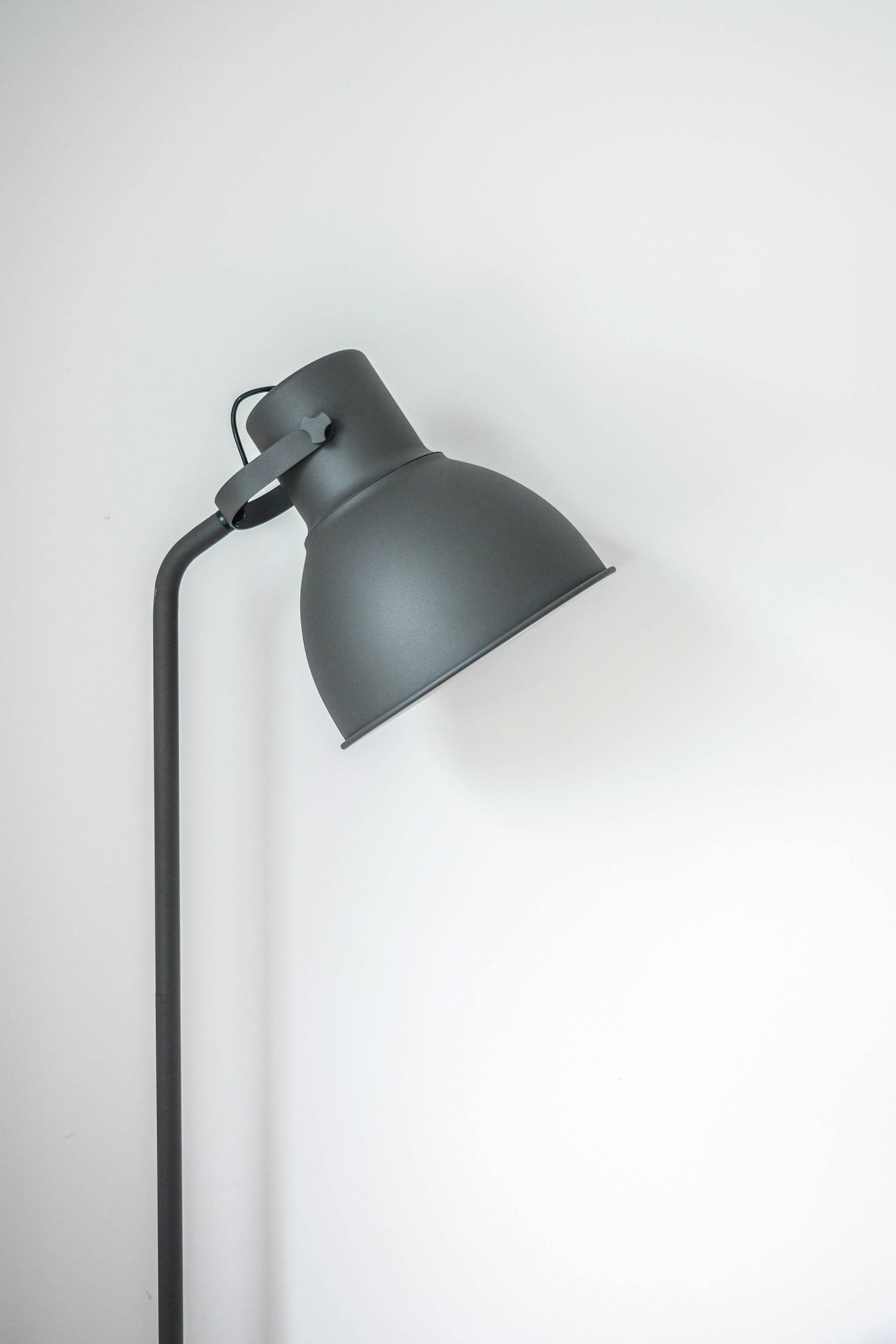 Warm desk lamp beside stationery
